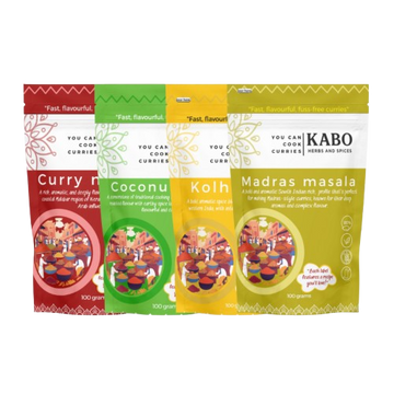 "Four packages of Kabo curry blends with colorful designs on a white background"